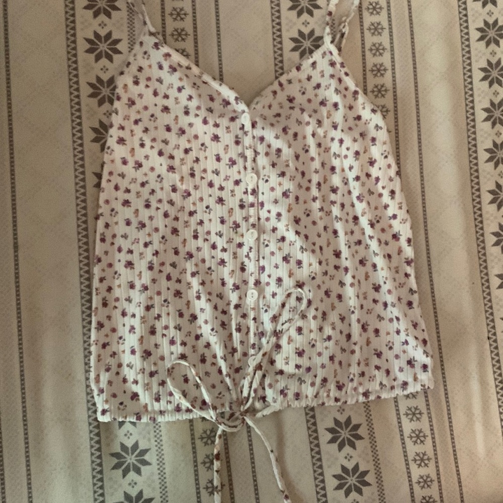 this is a tank top with buttons coming down the middle, with a Tie string